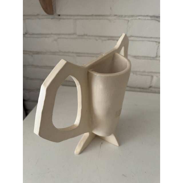Wonky urn shape with impressed leaves from the garden. Very Bloomsbury-ish . Cream colored clay with transparent glaze.