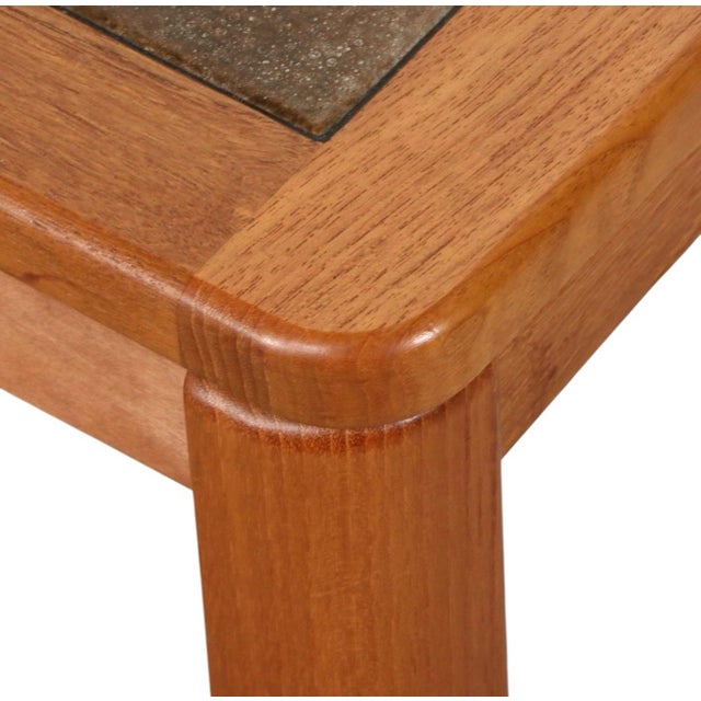 This Danish Modern rectangular coffee table ,:manufactured in 1985 through a collaboration between Haslev Møbelsnedkeri...