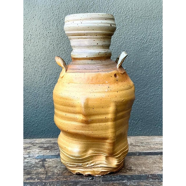 This vintage handcrafted studio pottery vase presents a robust, jug-like silhouette characteristic of traditional wood-...