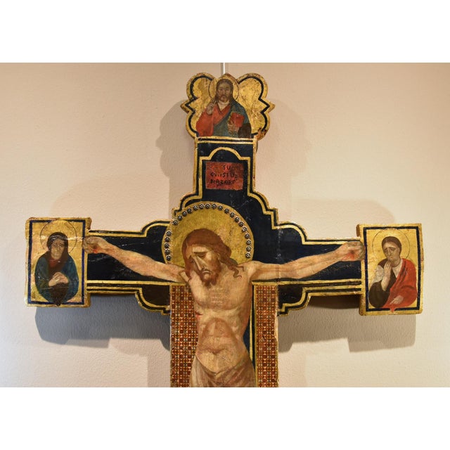 Crucifix (christus patiens) with god the father, the virgin, and saint john in the style of 14th-century tuscan painting...
