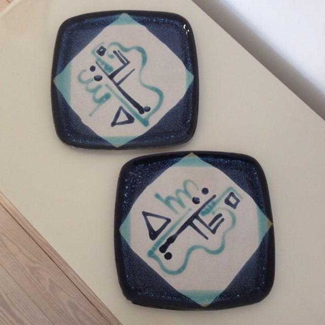 A pair of hand painted ceramic Glidden dinner plates. Made in America by Glidden Parker.