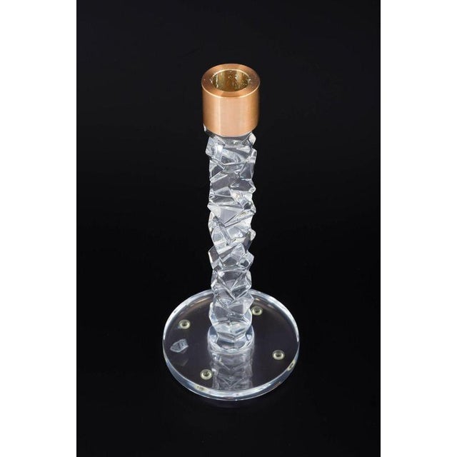 Orrefors, Sweden Candleholder in clear crystal with faceted, sculptural shaft and brass candleholder. Manufacturer:...