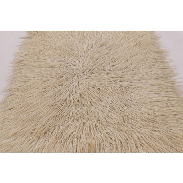 Made with hand-knotted high-pile wool in Turkey and originating circa 1950-1960, this 4x7 vintage Tulu rug is a...