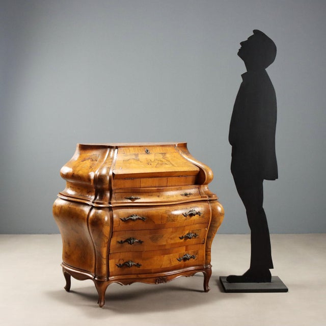 Baroque style bureau crafted in walnut and walnut burl, enhanced with elegant maple inlays. The structure features a...