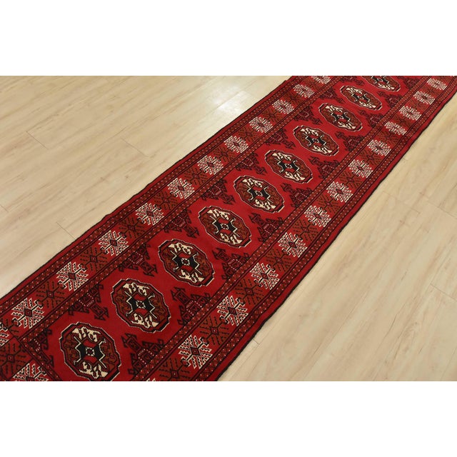 An authentic, vintage tribal Turkmen runner, hand-knotted with fine wool and natural dyes. This nomadic oriental rug...