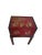 Elegant vintage chinoiserie accent table featuring a richly lacquered red storage chest raised on a warm-toned wood stand....