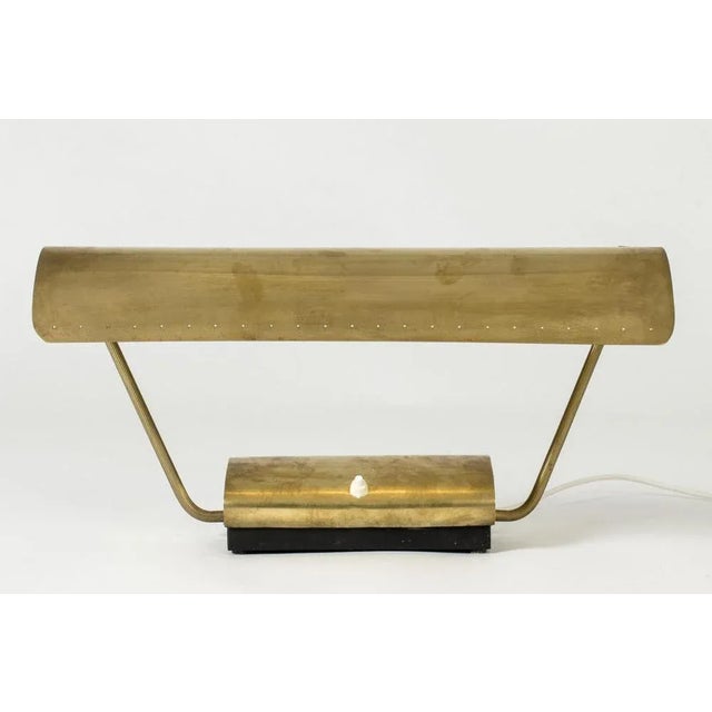 Cool midcentury desk lamp from Philips, made from brass in a wide design. Adjustable lamp shade with decorative perforated...