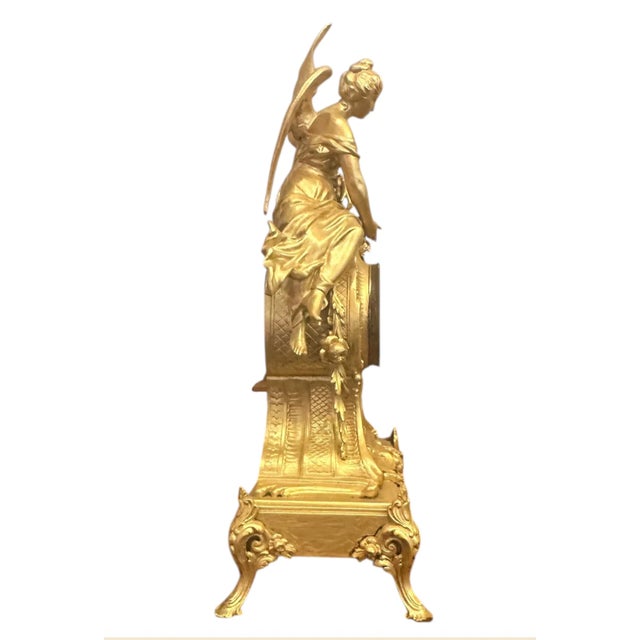 Antique Neoclassical Style Mantel Clock Ornate antique gilt metal mantel clock featuring a classical winged female figure...