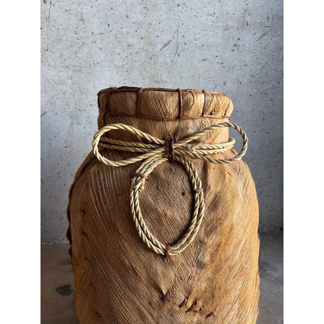 This large vintage primitive basket planter is a compelling example of hand-crafted folk art, distinguished by its...