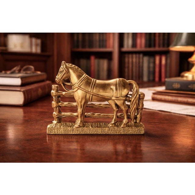 Vintage brass horse letter holder featuring an equestrian motif with detailed saddle and fence design, finished in a warm...