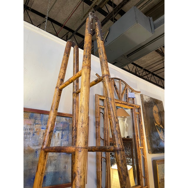A large scale 19th century folding double library ladder made of two sections of bamboo with an aged, mellow patina...