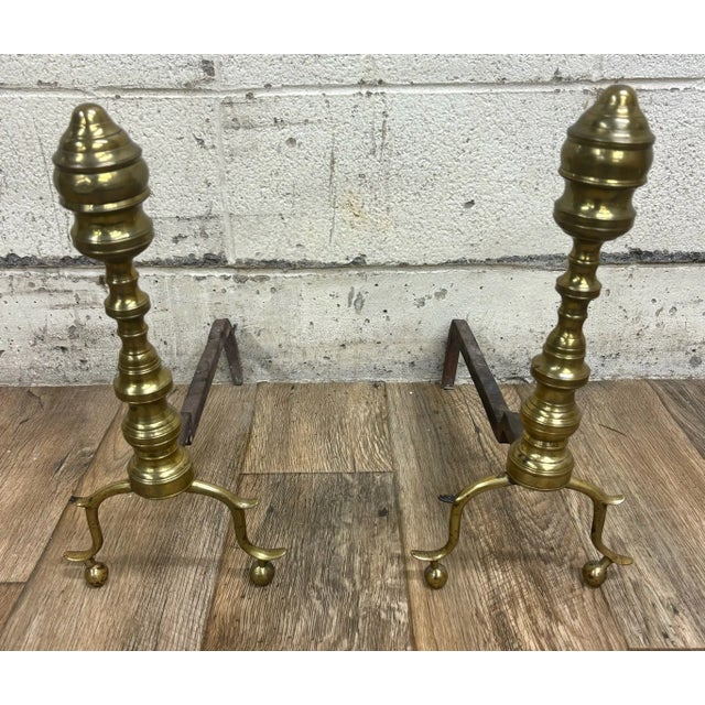 This is a stunning pair of vintage, possibly antique, brass and iron andirons with ball feet, in a Queen Anne style....