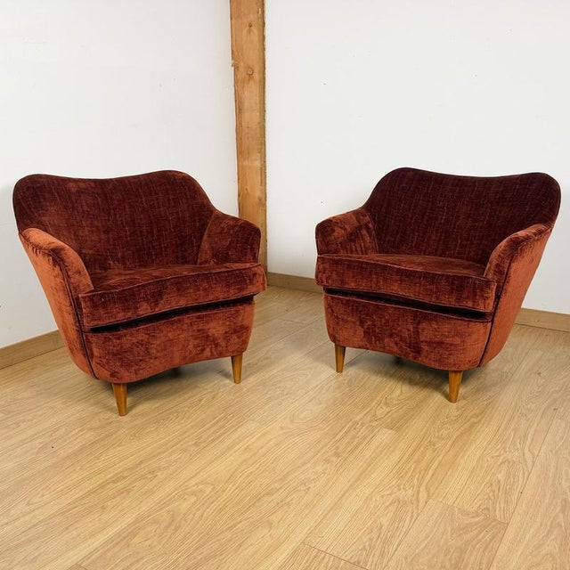 A pair of mid-century italian chairs with original walnut feet and burgundy fabric re-upholstery. Dimensions: h 74cm w...