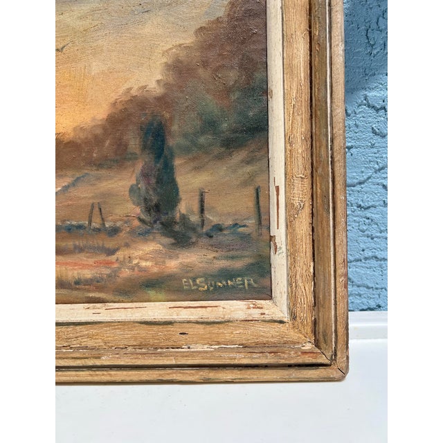 Vintage oil painting on board featuring a rural landscape scene at sunset. The painting is set in a wood frame The work is...