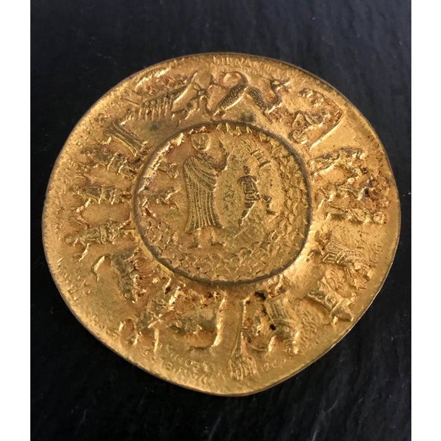A gilt bronze brooch "Moise ou la Traversee du Desert" by French Jeweler Line Vautrin, circa 1940s. The patinated surface...