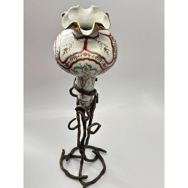 Medium sized standing vase, with crackle glaze, scalloped rim and gold glaze. Please note I believe the stand is bronze,...