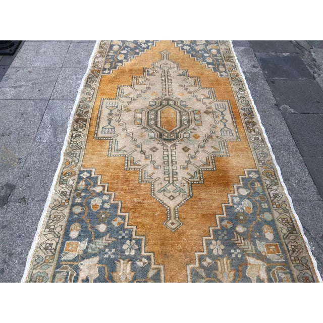 This is a vintage Turkish Oushak rug from the 1960s. The piece was hand-knotted.