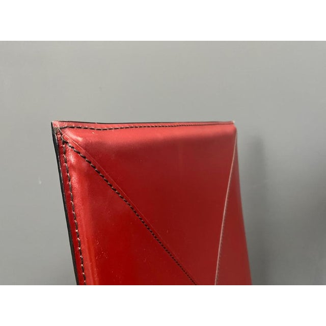 Set of 8 red stiched leather dining chairs byRoche Bobois, France. Very sturdy and timeless design chairs. Good condition....