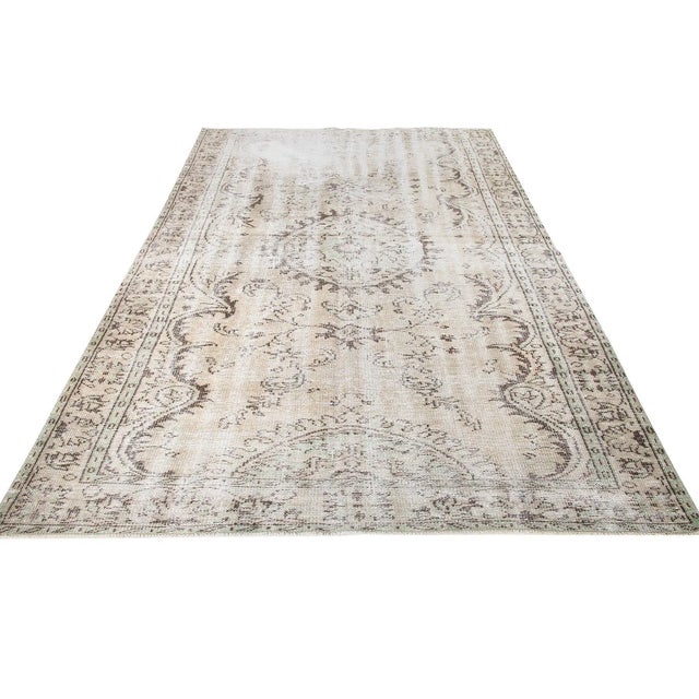 Decorative washed out handknotted vintage rug from Oushak region of Turkey. Approximately 50-60 years old. In very good...