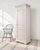 A charming single-door lacquered wood bonnetière or storage cabinet crafted in a Country French Provincial style. The...
