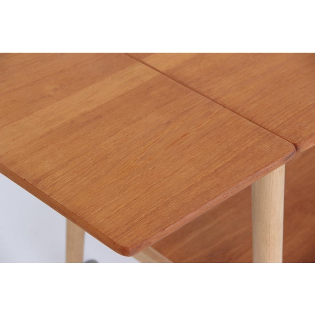 Beautiful Danish classic from the hand of Hans J Wegner, produced by Andras Tuck. The table is equipped with wheels on a...