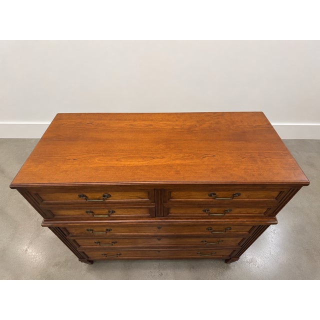 A mid-century modern 7 drawer dresser by Henredon Fine Furniture. Brass handles, inlaid borders all the way around. Faux...