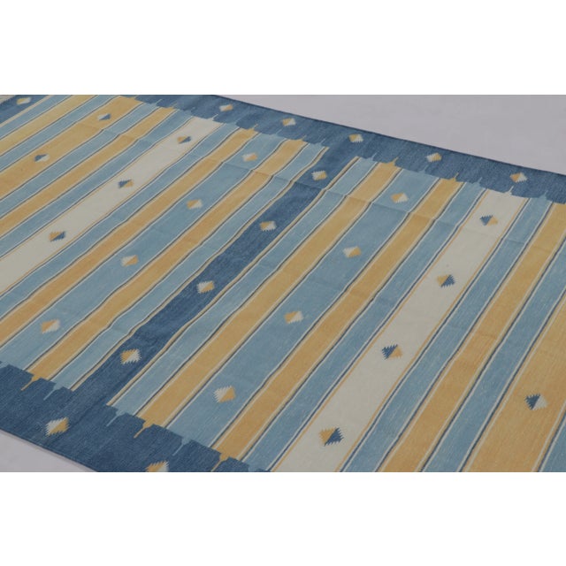 This 5 x 8 dhurrie from India, handwoven in cotton presents a lively yet balanced interpretation of traditional flatweave...