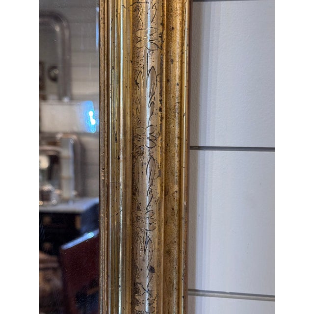 This is a gorgeous 19th Century Louis Philippe mirror! The mirror features a molded design with a hand carved pattern on...