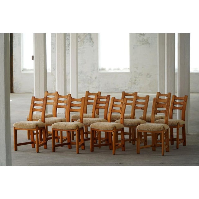 Set of 12 sculptural dining chairs in solid pine, reupholstered seats in a great quality lambswool. Made by Finsdahl...