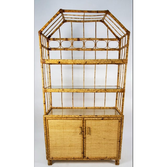 This stunning vintage étagère/display cabinet embodies the chic, relaxed elegance of coastal or tropical decor, often...