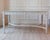 Swedish 1920s painted center table with a restrained neoclassical silhouette and original green marble top. The hand-...