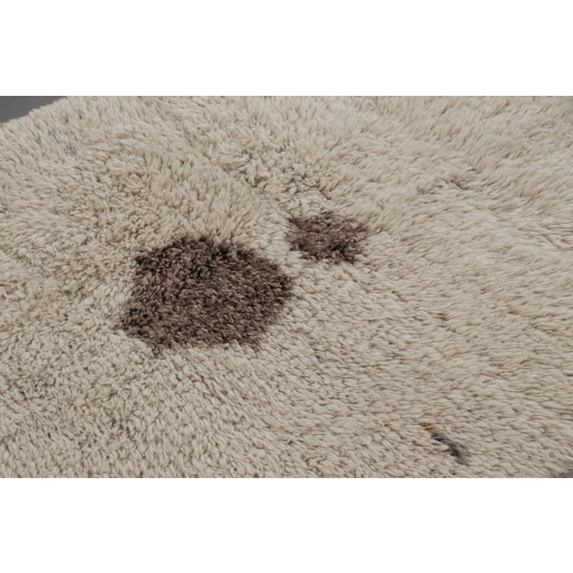 Hand-knotted in wool and originating from Turkey circa 1950-1960, this 5x7 vintage Tulu rug is a rich piece and the latest...