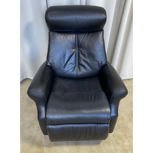 This Recliner has a plush design, high backrest, and thickly padded armrests suggesting a comfortable seating experience....