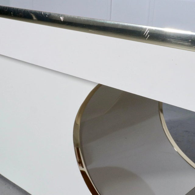 Sculptural brass trimmed laminate coffee table in the manner of Karl Springer. Circa 1980’s. Wonderful vintage condition...