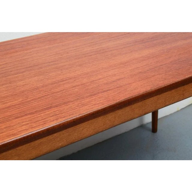 Elegant 60s coffee table, veneered in teak. Fine graceful design. Beautiful condition, only minor signs of use.