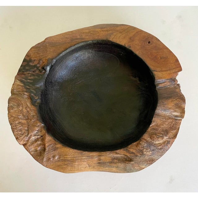 Here is a beautiful, natural wood bowl that has been hand-carved. I believe the center is burned black (but it could also...