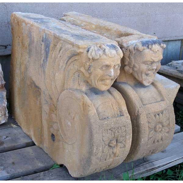 DETAILS A pair antique, scarce French stone figural brackets each carved with a grinning grotesque mask issuing from a...