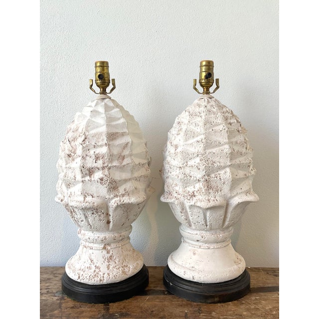 This pair of vintage plaster artichoke lamps serves as a sophisticated nod to Hollywood Regency flair and botanical...