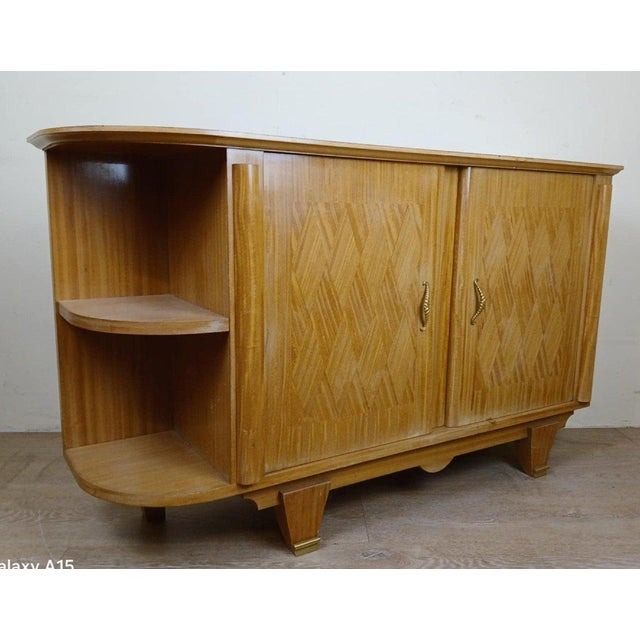 According to Jules Leleu: Rare corner buffet in light wood from the Art Deco period circa 1930. opening on the front with...