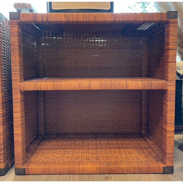 Pair of Handsome Vintage Rattan Nightstands. Featuring a warm caramel tone rattan and patinated brass campaign-style...