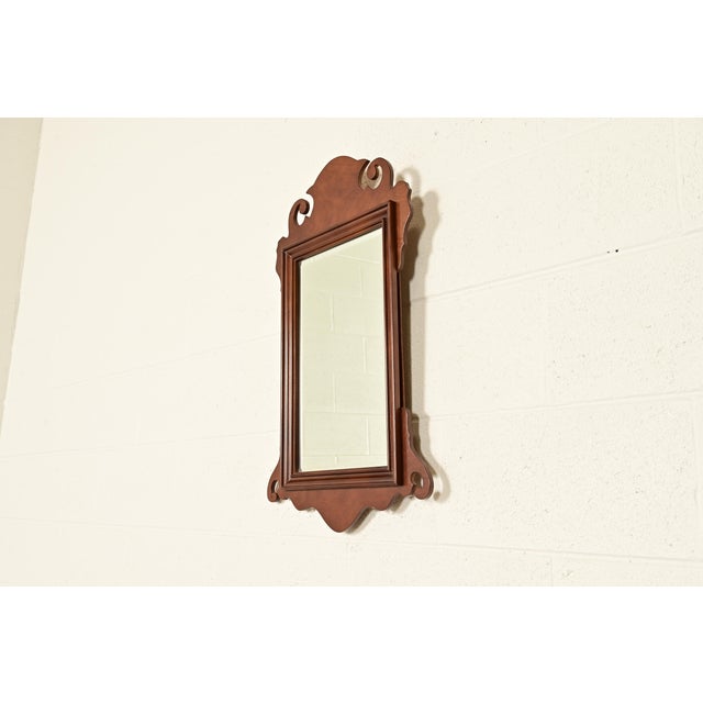 A gorgeous Georgian or Chippendale style carved mahogany framed wall mirror In the manner of Baker Furniture USA, Circa...