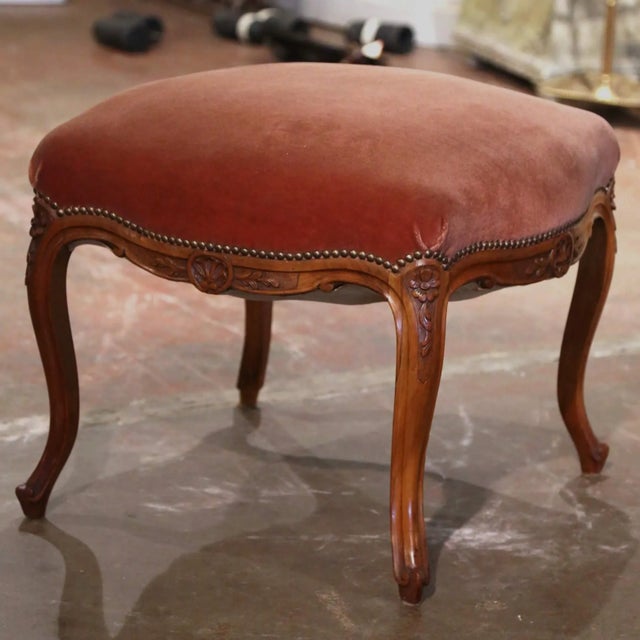 Crafted in Provence, Southern France circa 1920, this elegant antique Louis XV stool features a beautifully carved walnut...