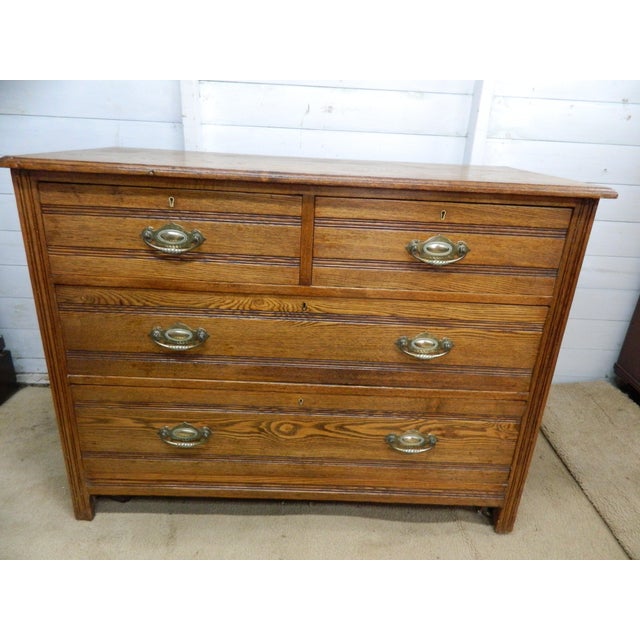 This Edwardian Oak Chest of Drawers is a classic piece of antique furniture with a country style design. Made from solid...