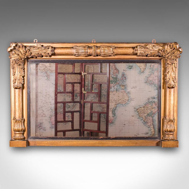 This is an antique overmantle mirror. An English, giltwood and gesso pier mirror, dating to the Regency period, circa...