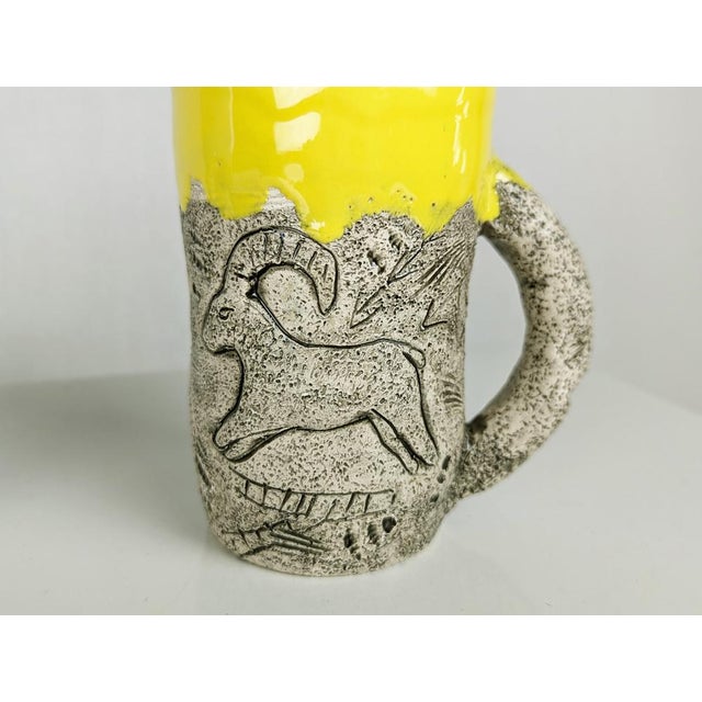 Set of 8 large ceramic cups decorated with African animal motifs in relief and covered with a thick layer of colored...