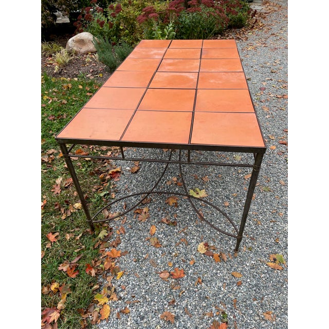 Rectangular vintage indoor /outdoor table with ceramic square tile inserts to top. The tiles and iron base have...