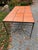 Rectangular vintage indoor /outdoor table with ceramic square tile inserts to top. The tiles and iron base have...