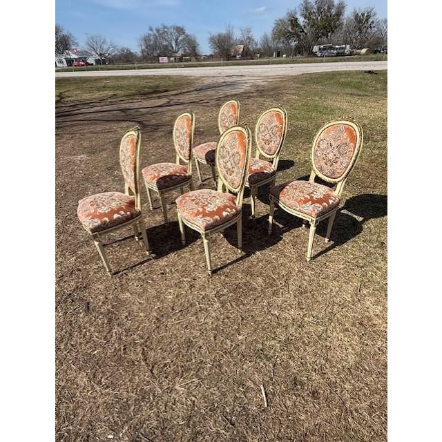 A set of six 19th century Louis XVI-style dining chairs featuring classic oval "medallion" backs, fluted tapered legs, and...