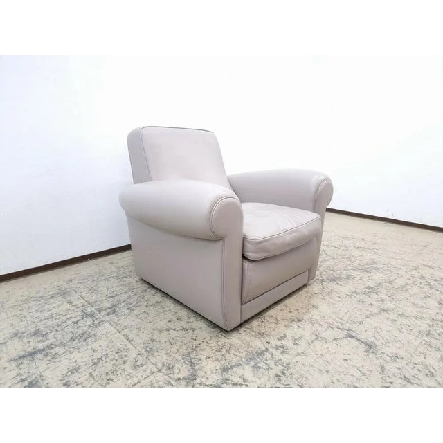 Baxter armchair "Mickey" in gray, real leather. The condition of the armchair is okay and has been restored by the...