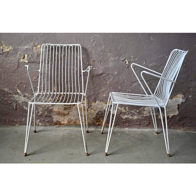 These outdoor armchairs are midcentury productions from the German firm Mauser Werke GmbH. Made of white lacquered metal,...